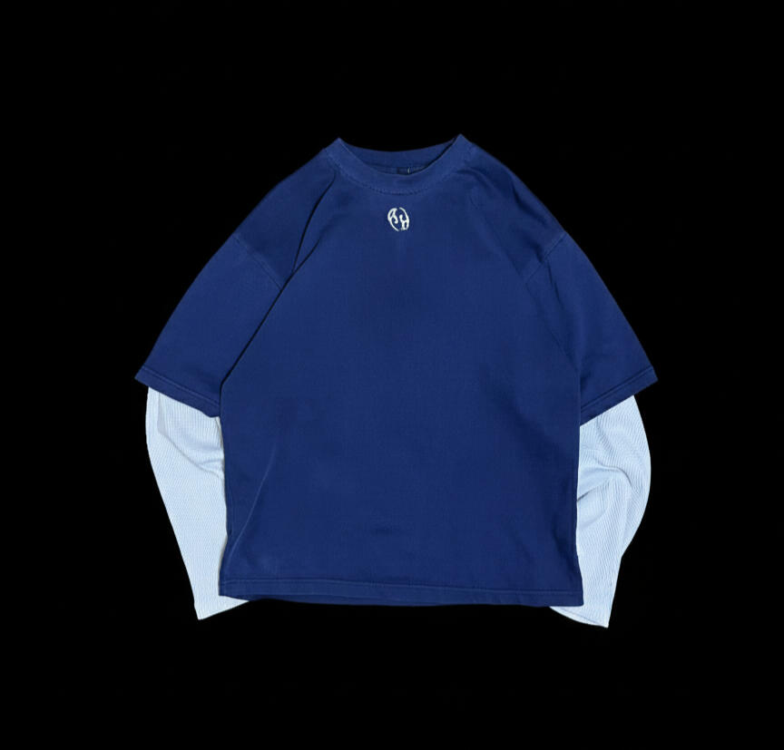 Navy boxy tee with a small embroidered logo, layered over a light blue waffle long sleeve